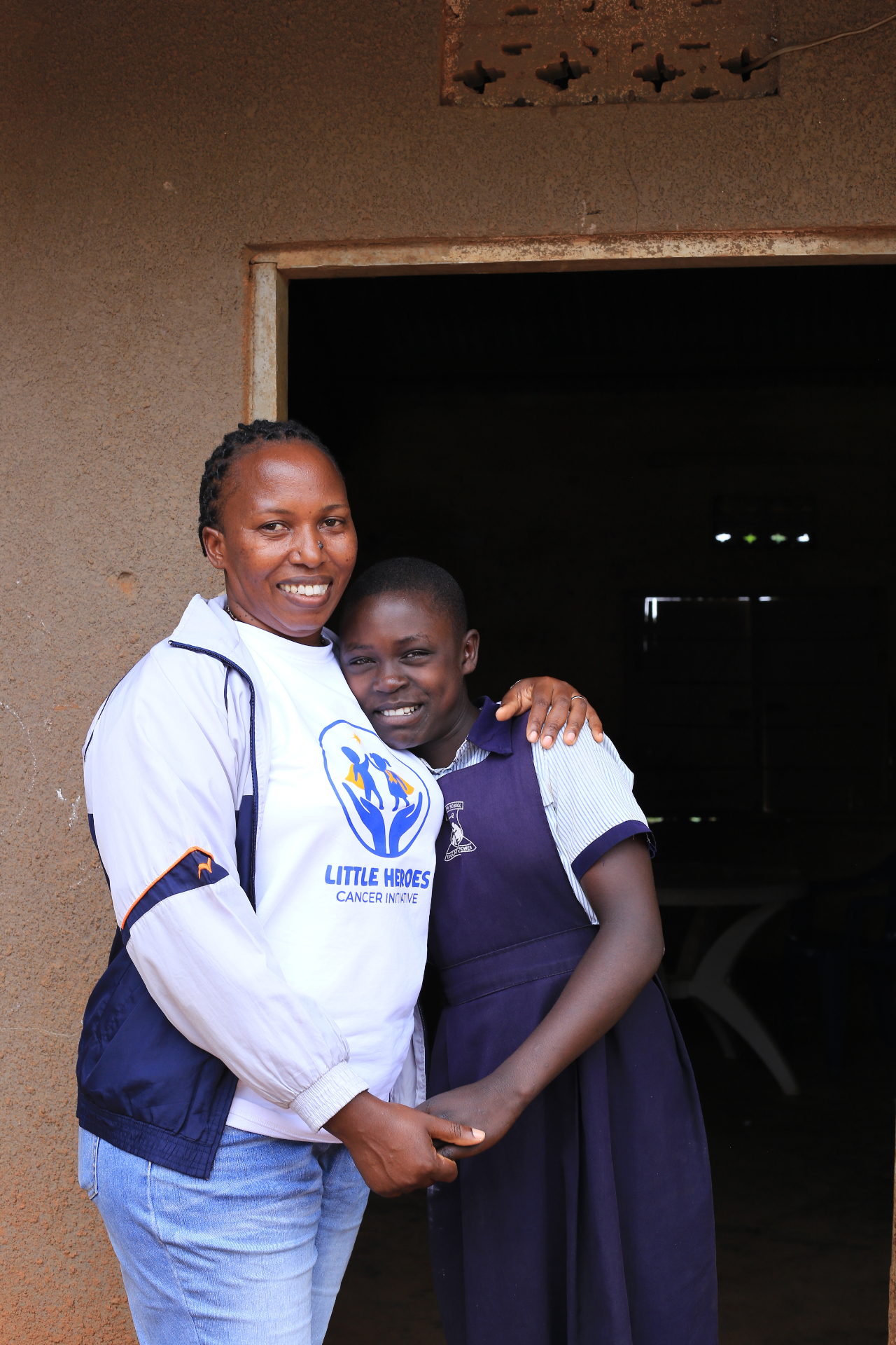 Atuhaire Aurelia embracing a schoolgirl