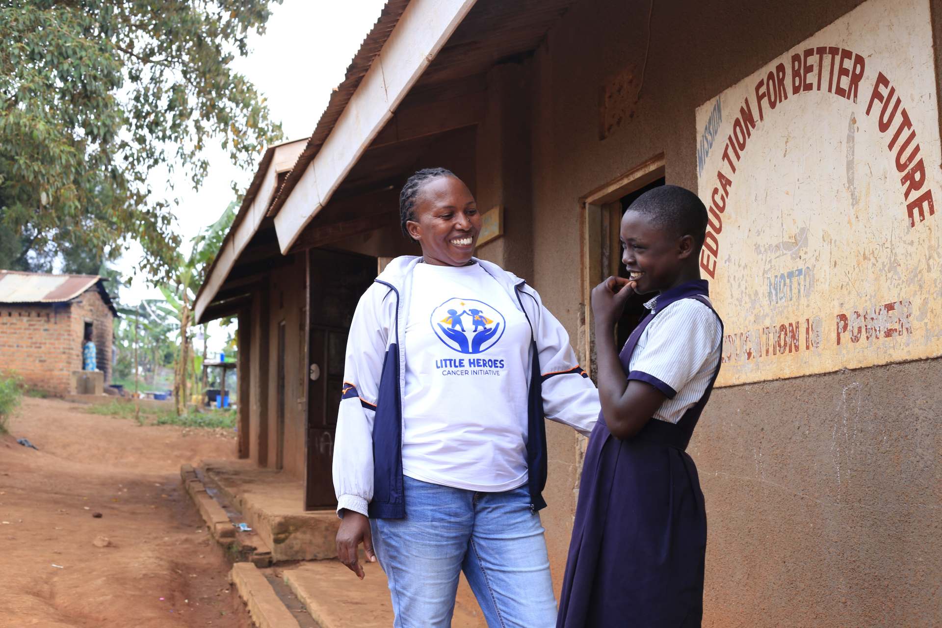 Atuhaire Aurelia sharing a joyful moment with a student at school
