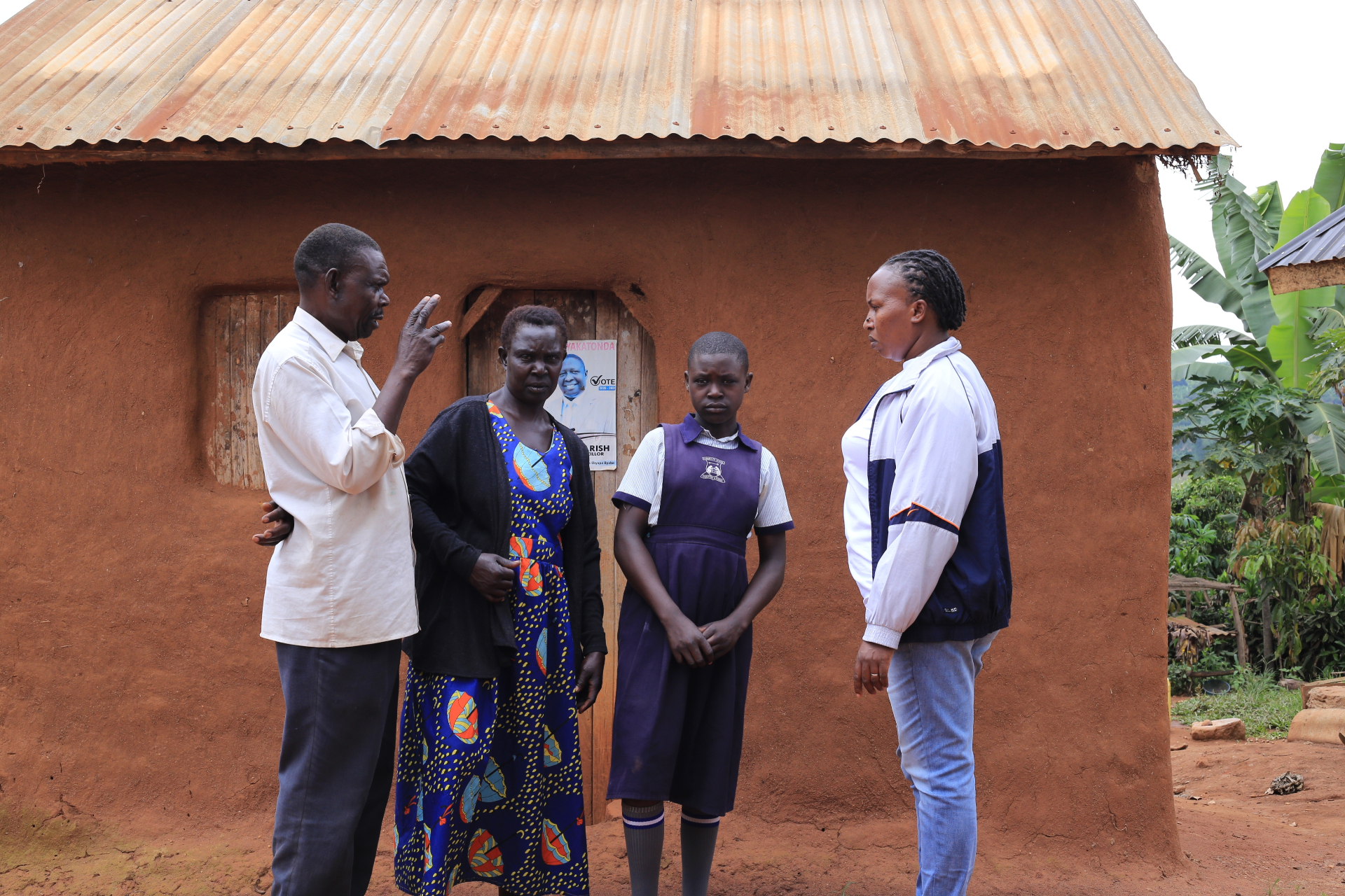 Little Heroes team member speaking with a family during a home visit